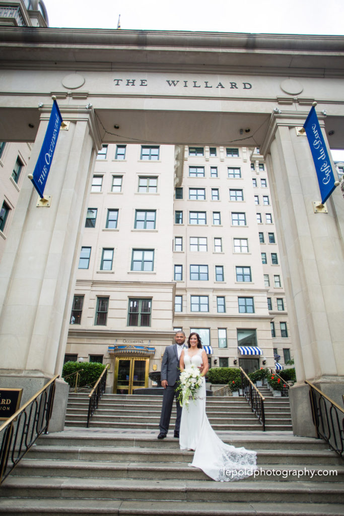 Bride and groom in front of the Willard Hotel on their wedding day