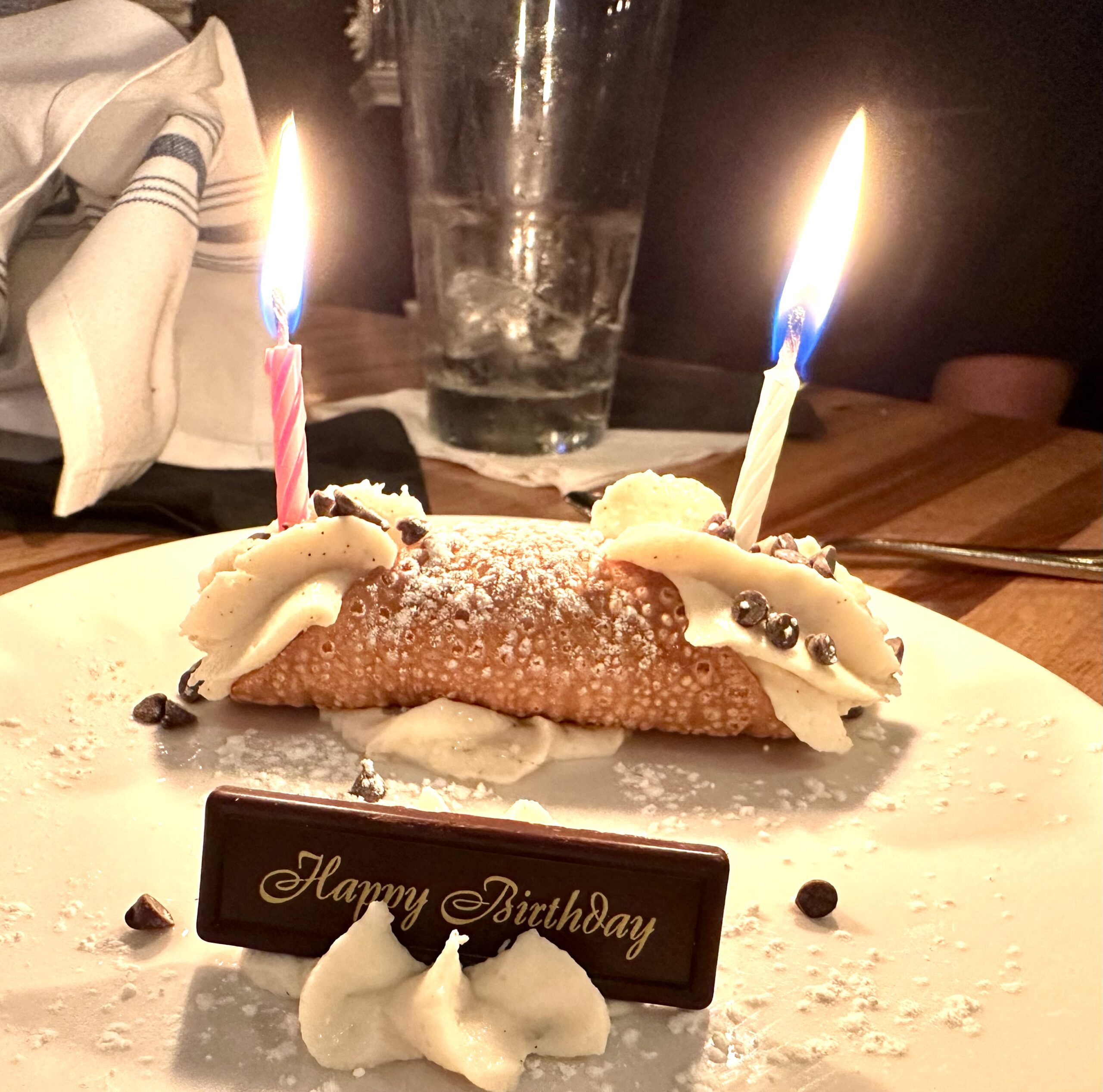 Birthday celebrations with Starbucks free drink and birthday cannoli with candles lit!