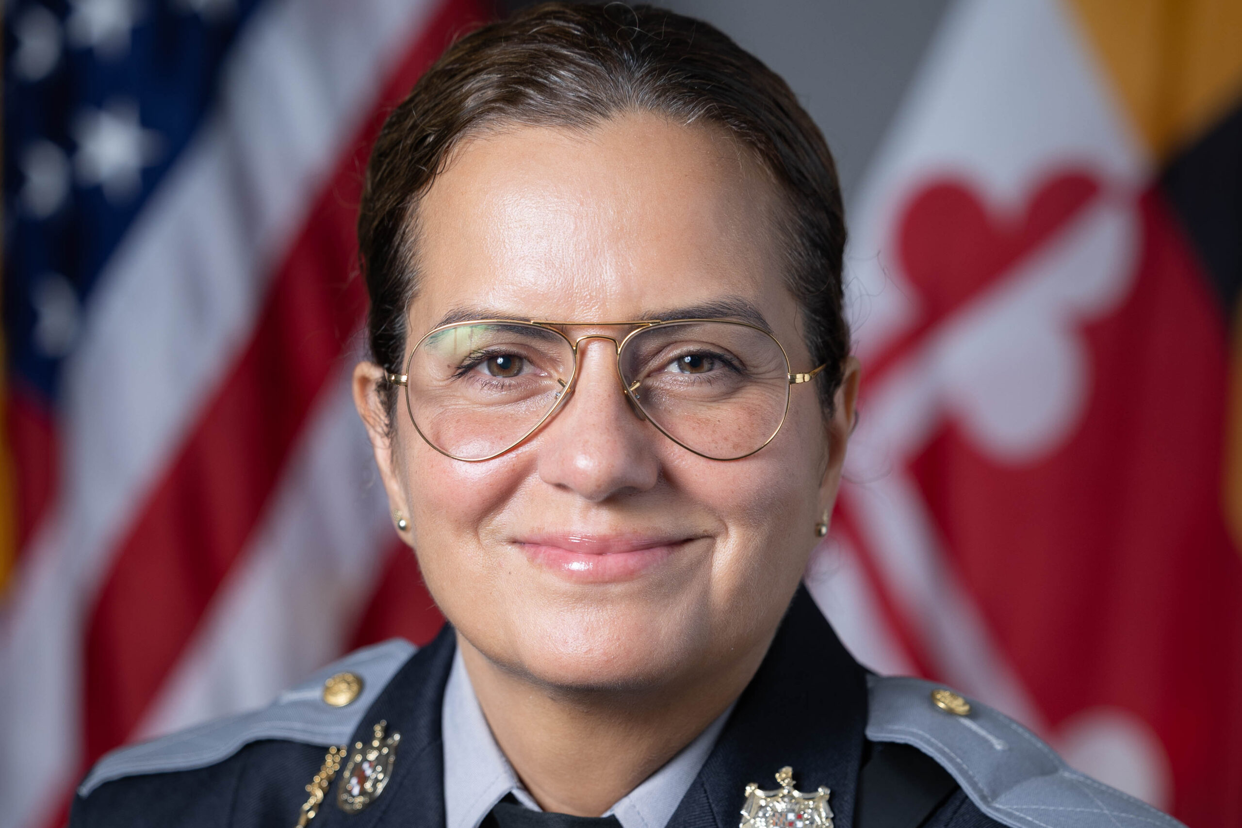 Berwyn Heights Police Officer Headshot with flags in the background