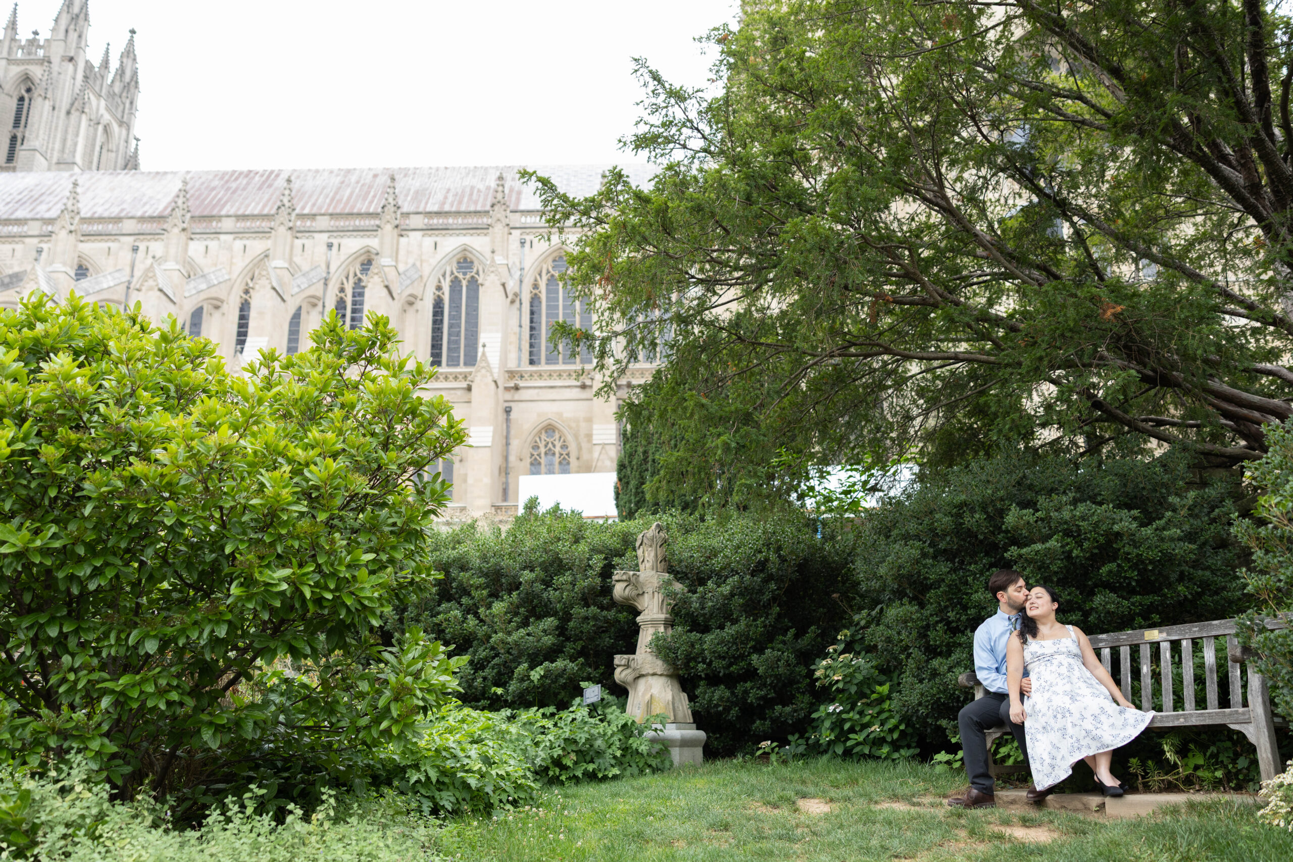 Engaged couple walking through Bishop's Garden at the Washington National Cathedral during a summer engagement photography session in Washington DC.