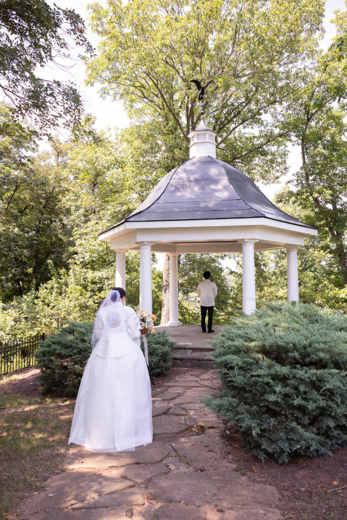 Joanna and Joshua in traditional Korean wedding attire at River Creek Club in Leesburg VA